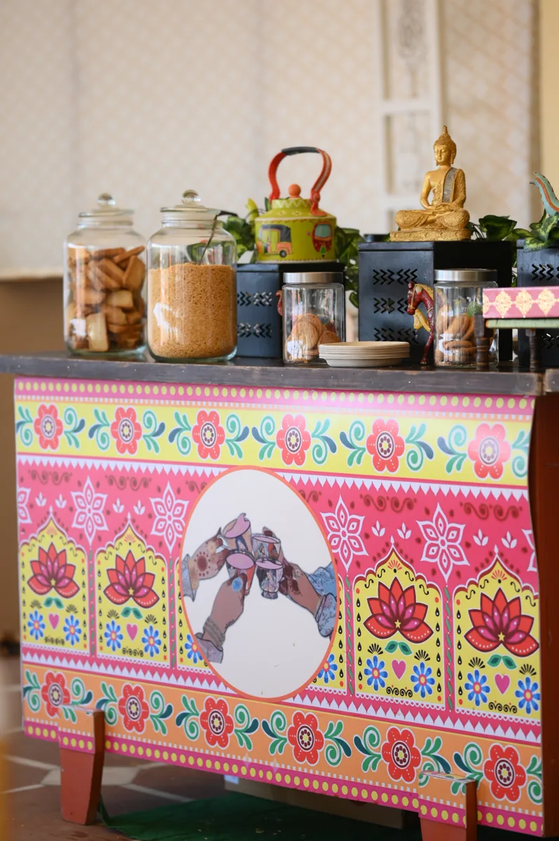 Truck-art styled Chapas chai counter with snack jars at an event
