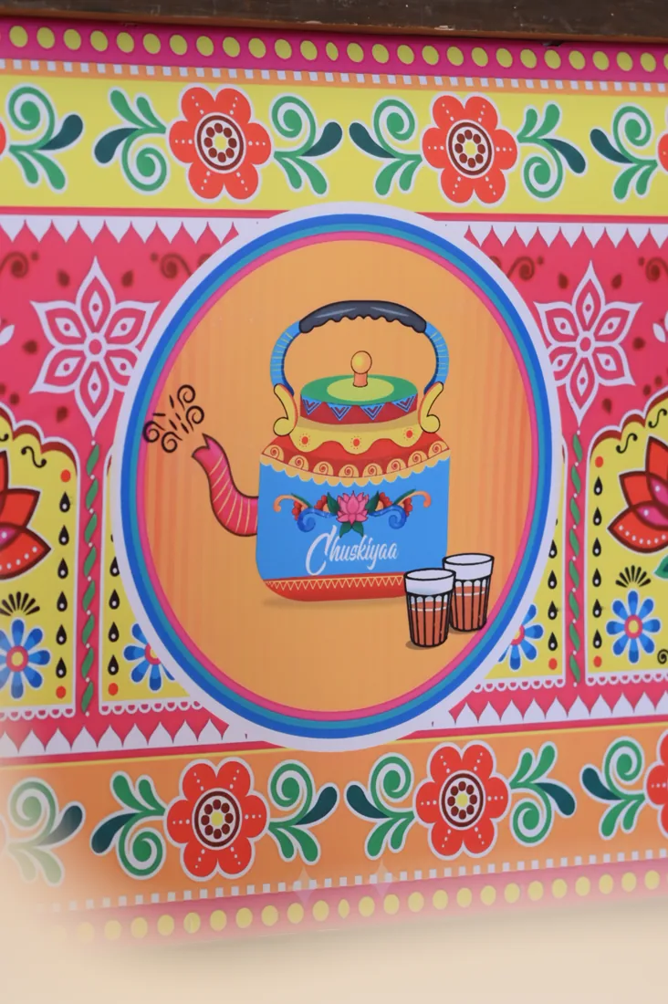 Truck-art panel with kettle and cutting chai illustration
